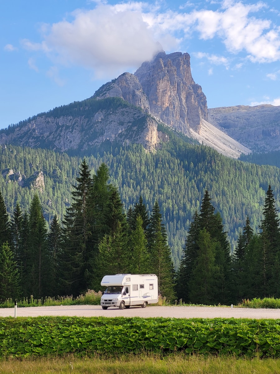 a recreational vehicle is parked in front of a mountain